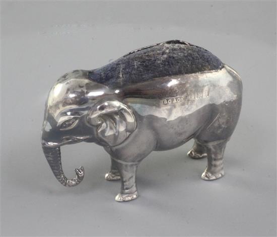 An Edwardian novelty silver pin cushion, modelled as an elephant by Britton, Gould & Co, length 7cm.